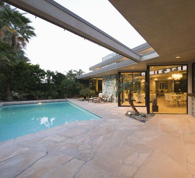 RSR View of swimming pool and illuminated modern home exterior